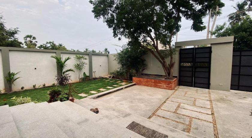 Front courtyard with a tree and gate