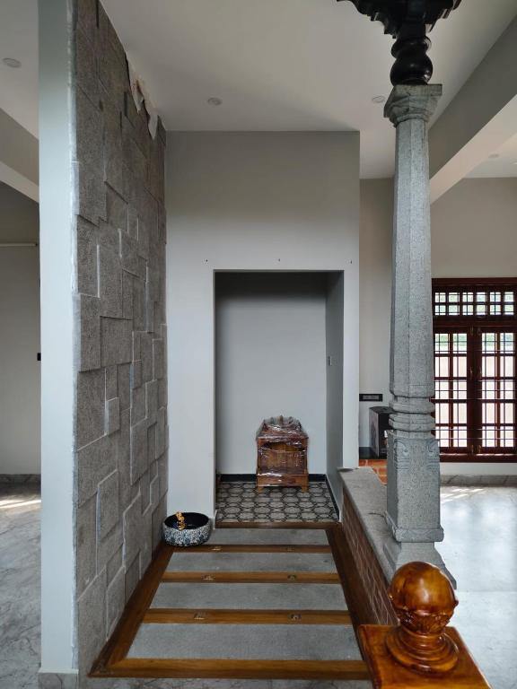 Stone-clad entrance corridor with a granite pillar
