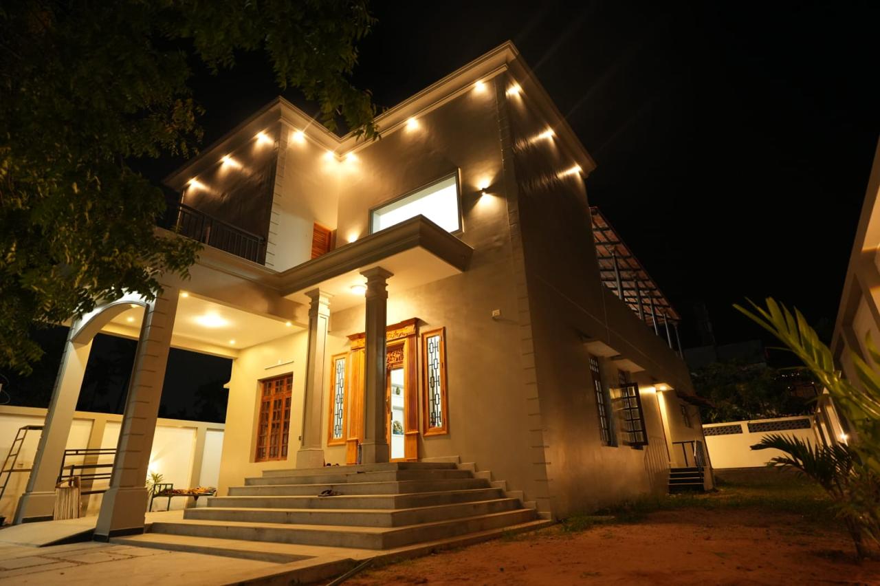Desert Beach House lit up at night