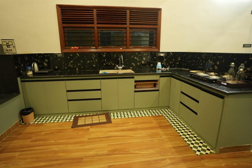 Full kitchen in the Superior Villa with a gas hob, sink and patterned floor tiles