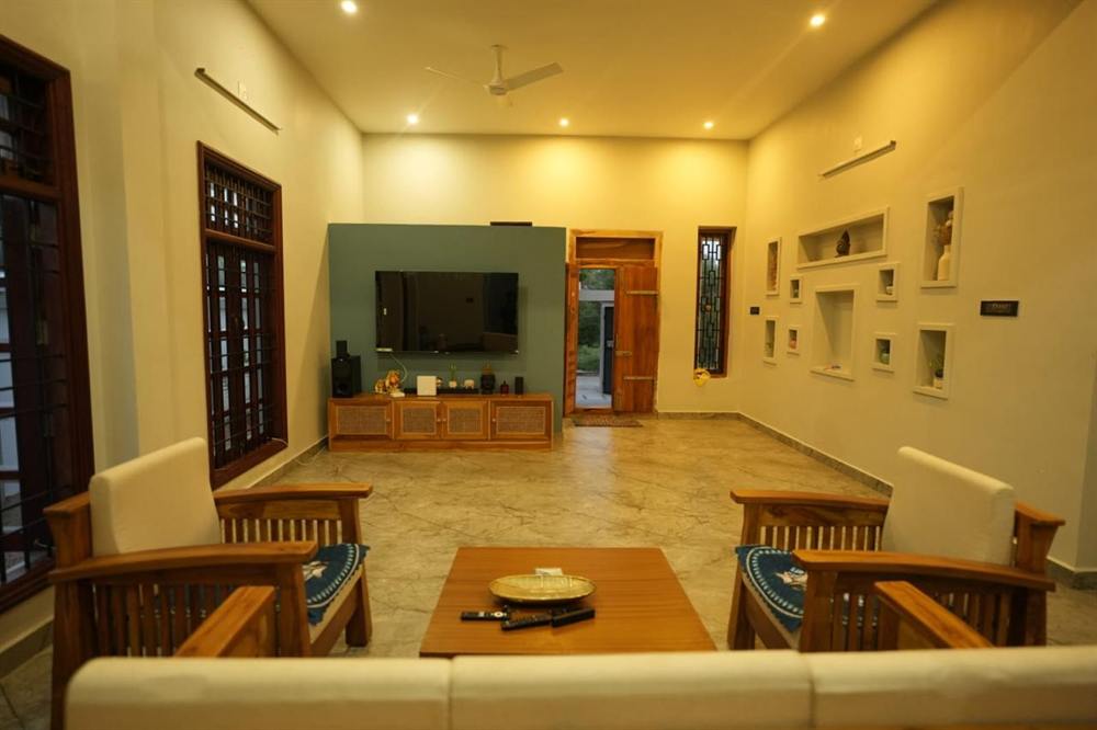 Superior Villa living room with teak seating, a large TV and display niches